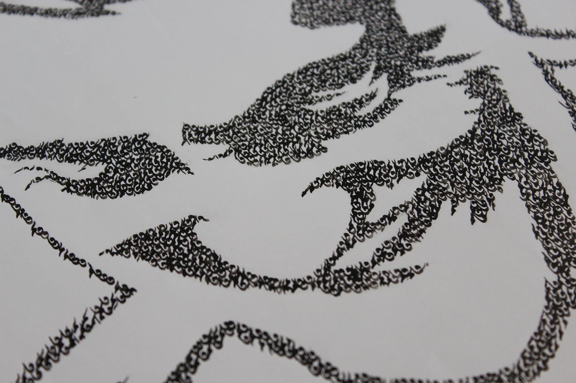 “Labkhand” by Ali Bagheri, a black-and-white portrait of a man whose facial contours and shadows are formed by repeated writi